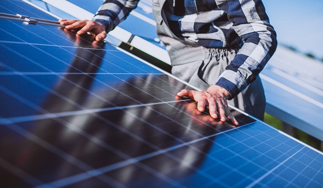 Man worker in the firld by the solar panels Man Worker In The Firld By The Solar Panels